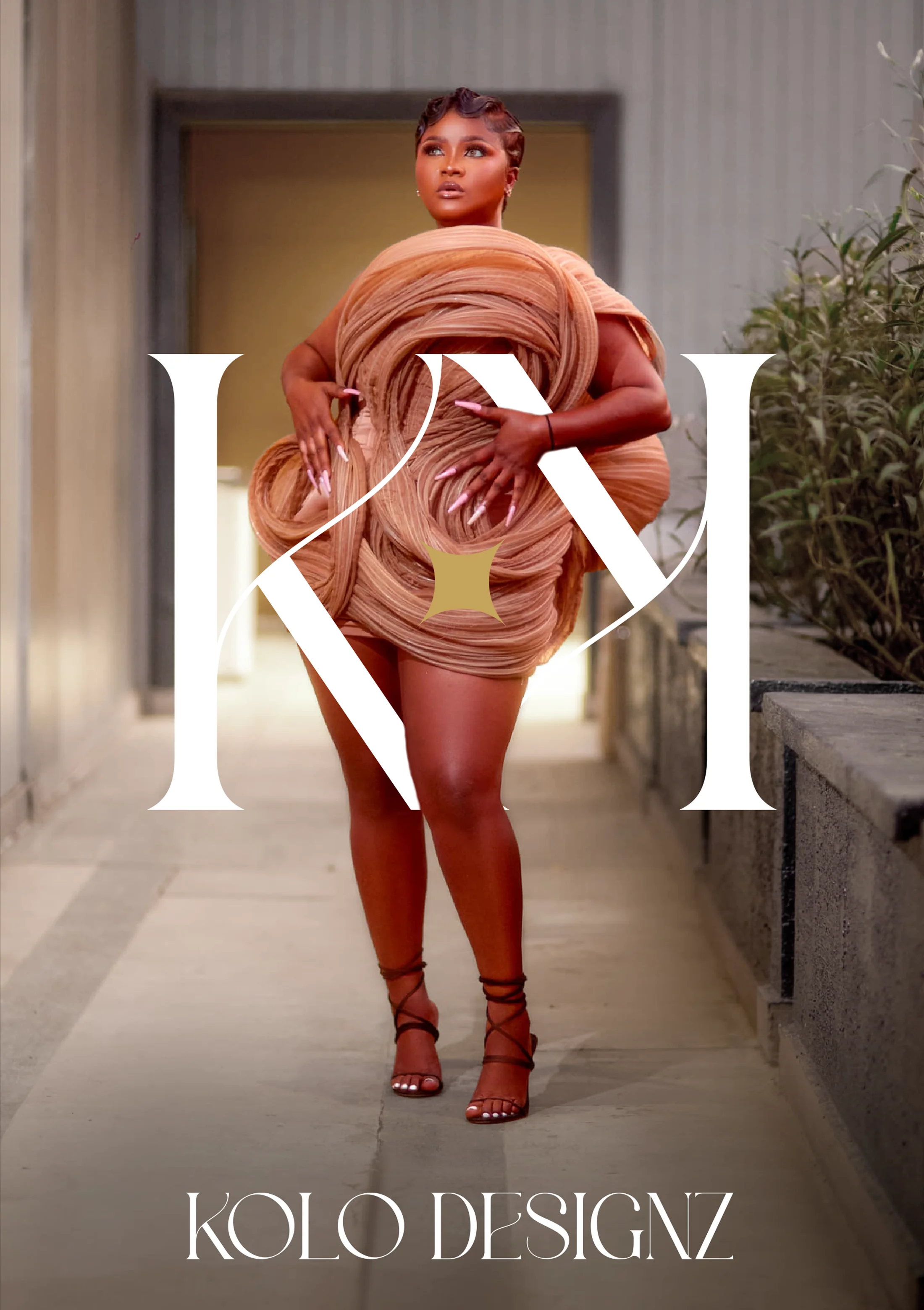 Chlautille Fobuzie, founder of Kolo Designz, in a sculptural Kolo Designz creation in an architectural corridor